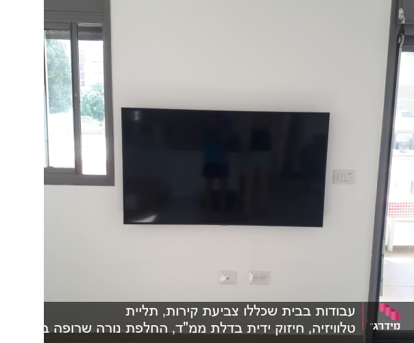 טלוויזיה תלויה על קיר עם שקעים חשמליים
